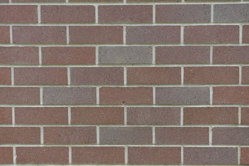 The Architectural Fine Red provides an exquisite close-up view of a red brick wall with gray mortar lines, highlighting the architectural elegance of its evenly arranged horizontal pattern.