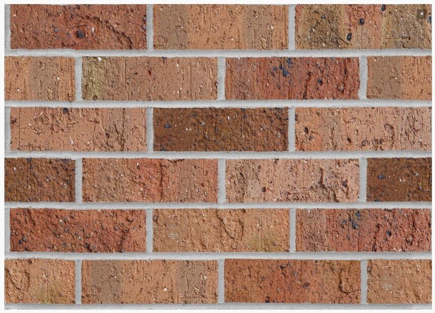 A wall crafted from Daniel Robertson Traditional Apricot bricks, laid out in a horizontal design, presents an exquisite mix of red and brown tones. The surface texture and subtle color variations enhance its depth and character, resulting in an inviting and timeless look.