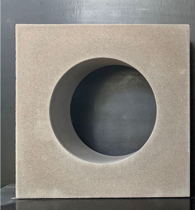 The Breeze Block Circular Grey is showcased against a dark background, featuring a large circular hole at its centre.