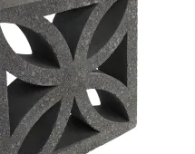 Close-up of a GB Breeze Blocks Flower Pewter Pottery breeze blocks unit with intersecting curved cutouts, forming a symmetrical, flower-like geometric pattern in dark grey concrete. The block is displayed against a white background, evoking arc pottery motifs.