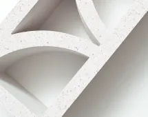A close-up of the GB Breeze Blocks Arc Pottery in light grey with speckled finish, featuring geometric curved and triangular cutouts, displayed diagonally on a white background.