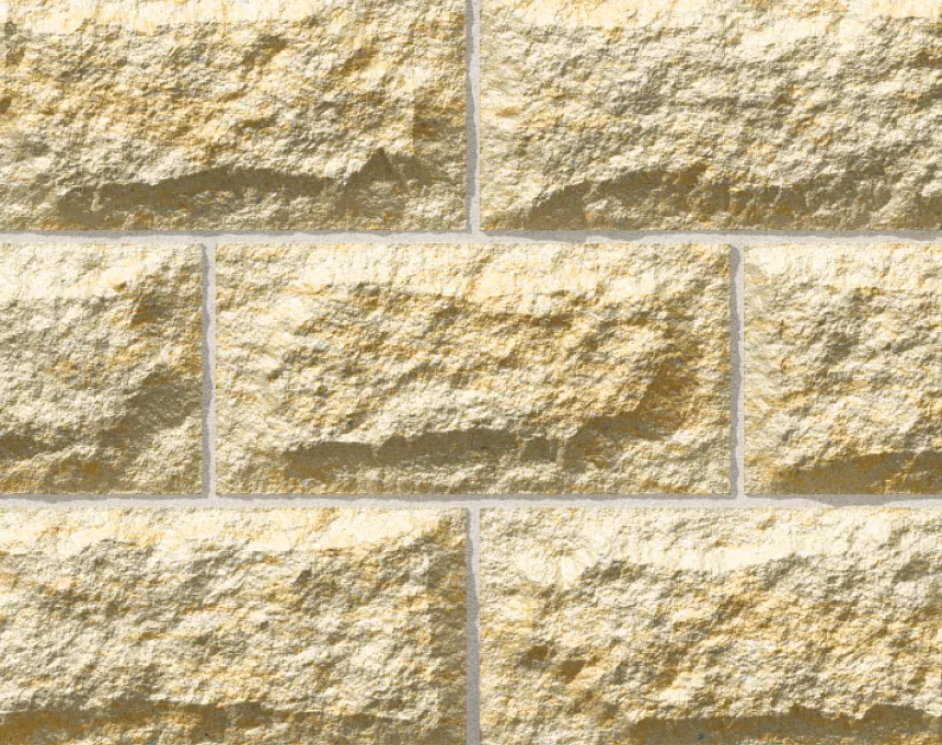 A close-up view of a beige and tan stone brick wall featuring GB Sandstone Rockface Sydney Blend, with rectangular stones, rough textured surfaces, and visible mortar lines.