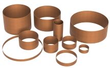 Several cylindrical and ring-shaped FormBoss Metal Edging bronze components of varying sizes are arranged on a white background.